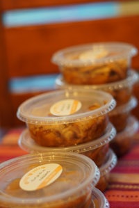 a row of plastic containers with food in them