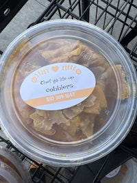 a plastic container filled with food on a cart